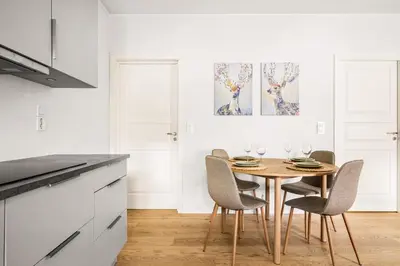 a dining room with a table and chairs at Light & Modern, City Apartment in Bergen