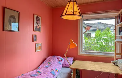 a bedroom with a bed and a desk and a lamp at Lovely Home In Hamar With Wifi in Hamar