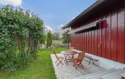 a patio with a table and chairs next to a building at Lovely Home In Hamar With Wifi in Hamar