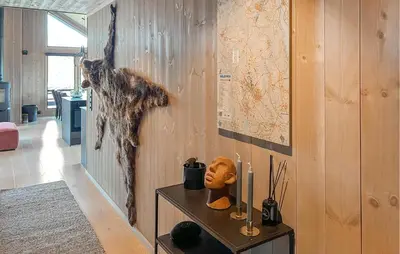 a cat hanging on a wall in a room at Cozy Home In Svingvoll With House A Mountain View in Svingvoll