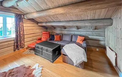 a living room with a couch and a stove at Nice Home In Lillehammer in Lillehammer