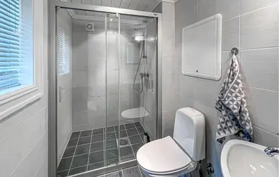 a bathroom with a shower and a toilet and a sink at Nice Home In Lillehammer in Lillehammer