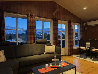 a living room with a couch and a table at Cosy ski-in ski-out mountain cabin with sauna in Trysil