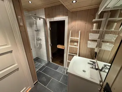 a bathroom with a sink and a shower at Cosy ski-in ski-out mountain cabin with sauna in Trysil