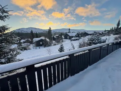 a winter view of a town with snow and houses at Cosy ski-in ski-out mountain cabin with sauna in Trysil