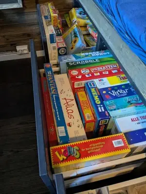 a pile of books sitting on a shelf at Luxury Mountain Cabin with Hot Tub and Views in Budal in Storen