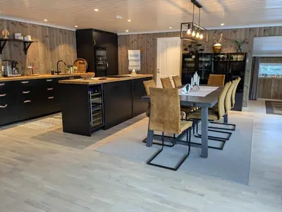 a kitchen with a table and chairs in a room at Luxury Mountain Cabin with Hot Tub and Views in Budal in Storen