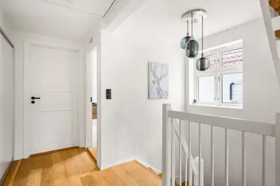 a hallway with white walls and a white door at Spacious Gem In Old Town I NEW 2025 I 3 Bed 2 Bath in Bergen