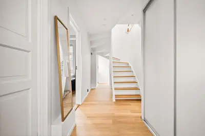 a hallway with white walls and a stair case at Spacious Gem In Old Town I NEW 2025 I 3 Bed 2 Bath in Bergen