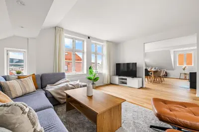 a living room with a couch and a tv at Spacious Gem In Old Town I NEW 2025 I 3 Bed 2 Bath in Bergen