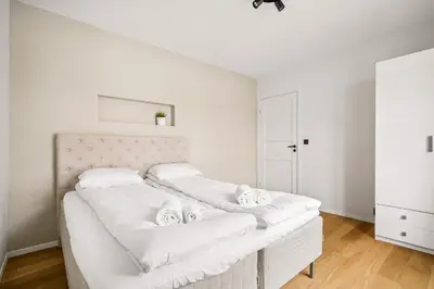 a white bedroom with a bed with white sheets at Spacious Gem In Old Town I NEW 2025 I 3 Bed 2 Bath in Bergen