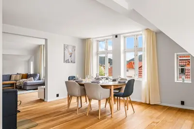 a dining room with a table and chairs at Spacious Gem In Old Town I NEW 2025 I 3 Bed 2 Bath in Bergen