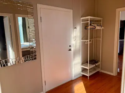 a room with a white door and a mirror at Charming apartment Nygårdsparken in Bergen