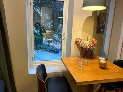 a person taking a picture out of a window at Apartment in apartment building, close to the train station in Bergen