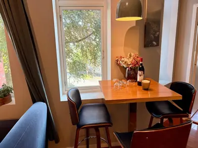 a dining room table with chairs and a window at Apartment in apartment building, close to the train station in Bergen