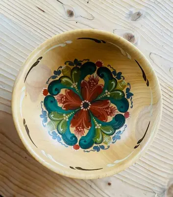 a wooden plate with a flower painted on it at Traditional Cabin With Annex In The Mountains in Gol