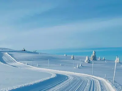 a snow covered road with tracks in the snow at Traditional Cabin With Annex In The Mountains in Gol