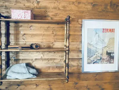 a shelf on a wall with a picture and a picture at Traditional Cabin With Annex In The Mountains in Gol