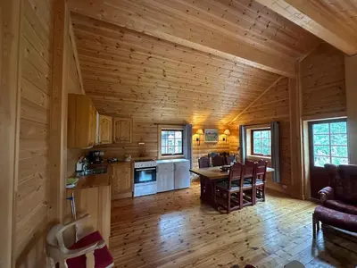 a kitchen and living room of a log cabin at Bjorliheimen Fjellhotell-Hytte 11 & 12 in Bjorli