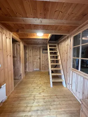 a room with wooden walls and stairs in a log cabin at Bjorliheimen Fjellhotell-Hytte 11 & 12 in Bjorli