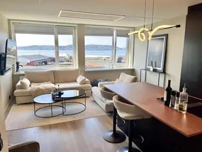 a living room with a couch and a table at Spectacular view 2 roms apartment in Bergen