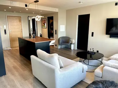 a living room with a couch and a table at Spectacular view 2 roms apartment in Bergen