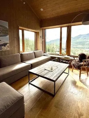 a living room with a couch and a coffee table at Lodge With Views Of Gaustatoppen Mountain in Rjukan