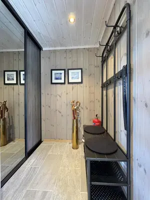 a room with a row of stalls in a dressing room at Bjørnebo, Family cabin in Torpo