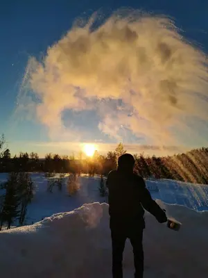 a person standing in the snow with a snowboard at Bjørnebo, Family cabin in Torpo
