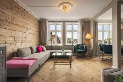 a living room with a couch and a table at Exclusive & Charming Apartment in Bergen