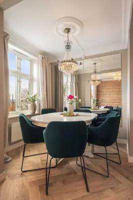 a dining room with a table and chairs and a chandelier at Exclusive & Charming Apartment in Bergen
