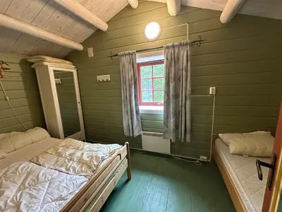 a room with two beds and a window at Bjorliheimen Fjellhotell-Hytte 4 og 16 in Bjorli