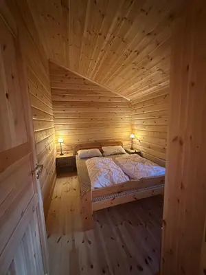 a large wooden room with a bed in a wooden room at Bjorliheimen Fjellhotell-Hytte 4 og 16 in Bjorli
