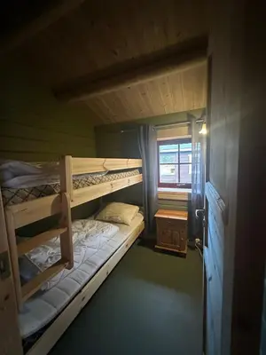 two bunk beds in a room with a window at Bjorliheimen Fjellhotell-Hytte 4 og 16 in Bjorli