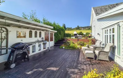 a patio with chairs and a grill on a house at Stunning Home In Vikebygd With House A Mountain View in Vikebygd