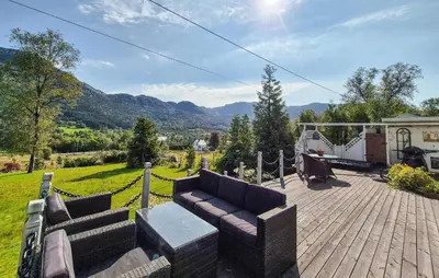 a patio with a couch on a wooden deck at Stunning Home In Vikebygd With House A Mountain View in Vikebygd