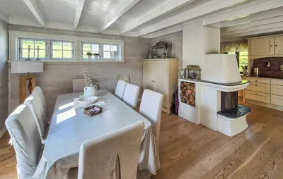 a dining room with a table and chairs and a stove at Stunning Home In Vikebygd With House A Mountain View in Vikebygd