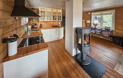 a kitchen with a woodburning stove in the middle at Amazing Home In Veggli With Wifi in Veggli