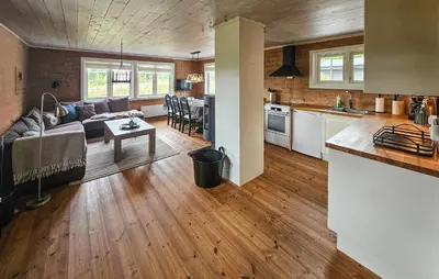 a kitchen and living room with a couch and a table at Amazing Home In Veggli With Wifi in Veggli