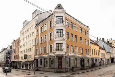 a large building on a city street with at DINBNB Apartment l 200m to Torgallmenningen l High-End Bergen Stay l Steps from Center in Bergen