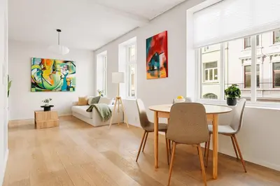 a living room with a table and chairs and a couch at DINBNB Apartment l 200m to Torgallmenningen l High-End Bergen Stay l Steps from Center in Bergen