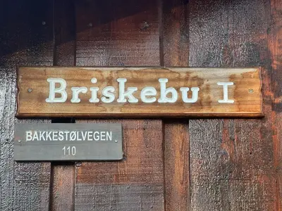 a wooden door with a sign that says briskleton i at Briskebu, cosy cabin by ski slopes in Geilo