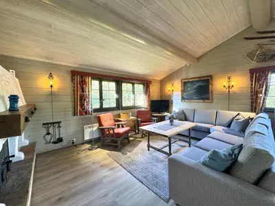 a living room with a couch and a table at Briskebu, cosy cabin by ski slopes in Geilo