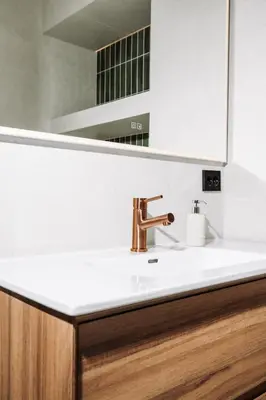 a bathroom with a sink and a mirror at Large city apartment with sea view and parking in Ålesund