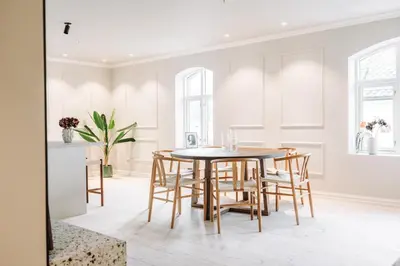 a dining room with a table and chairs at Large city apartment with sea view and parking in Ålesund