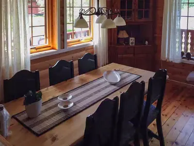 a dining room table with plates and bowls on it at Renovated Cabin By Lake Djupedal in Bygstad