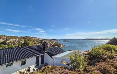 a white house with a view of the water at 4 Bedroom Gorgeous Home In Steinsland in Steinsland