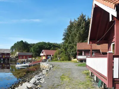 a group of buildings next to a body of water at 6 person holiday home in Bud-By Traum in Bud