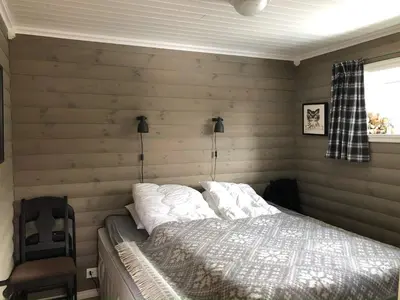 a bedroom with a bed in a room with wooden walls at 12 person holiday home in Skare-By Traum in Skare