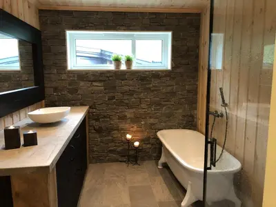 a bathroom with a tub and a toilet and a sink at 12 person holiday home in Skare-By Traum in Skare